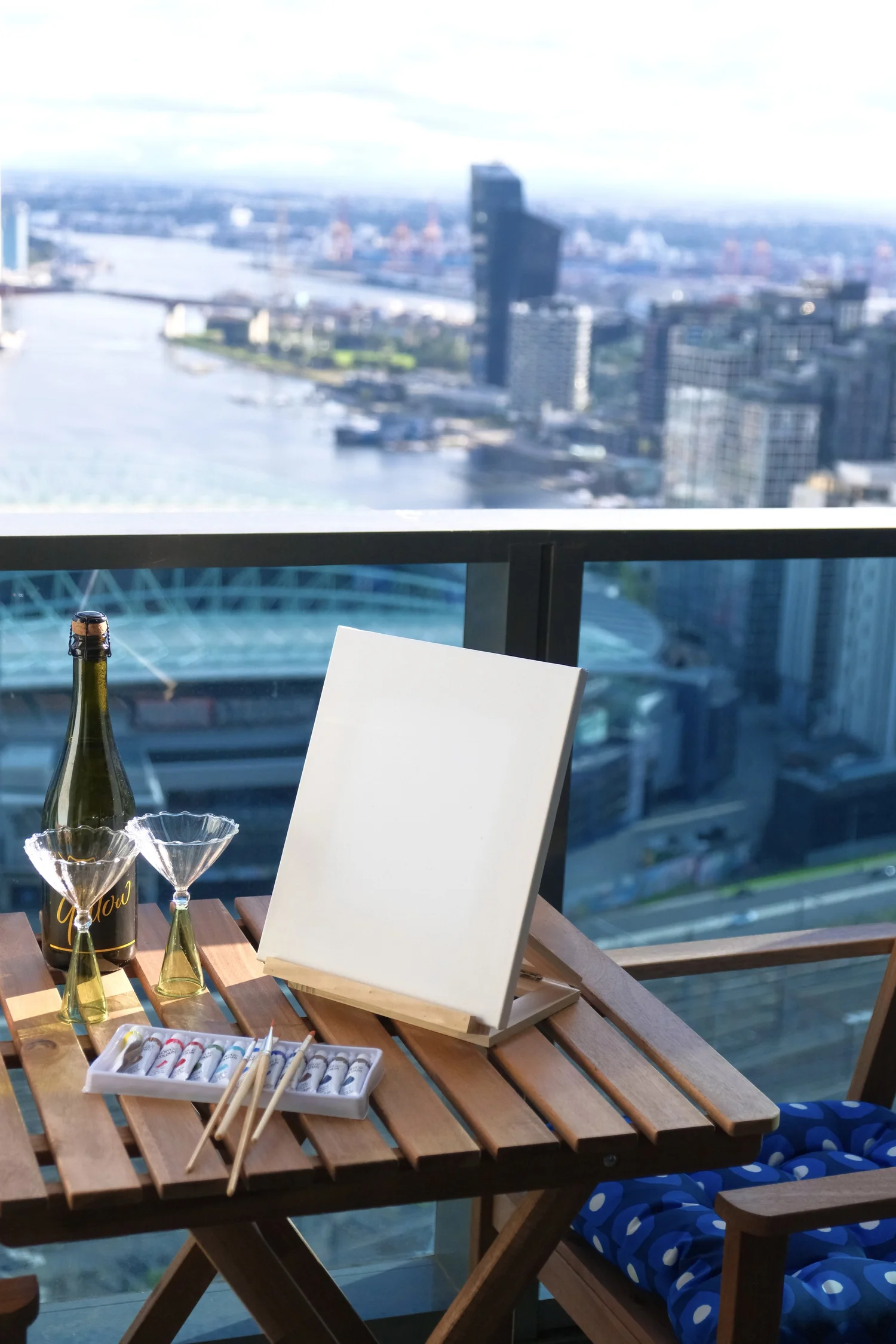 A furnished apartment balcony overlooking Melbourne and the Yarra River